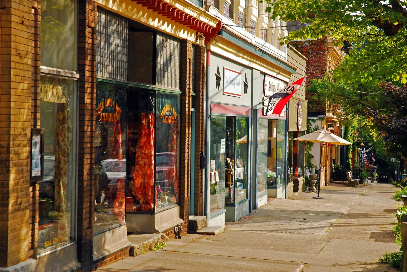 Charming small-town main street with antique shops and local storefronts, showcasing traditional retail and community-focused commerce.