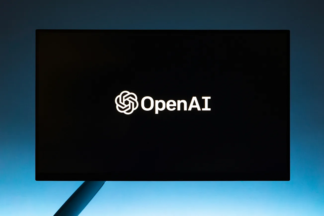 A dark screen displays the OpenAI logo and name in white, centered on a black background.