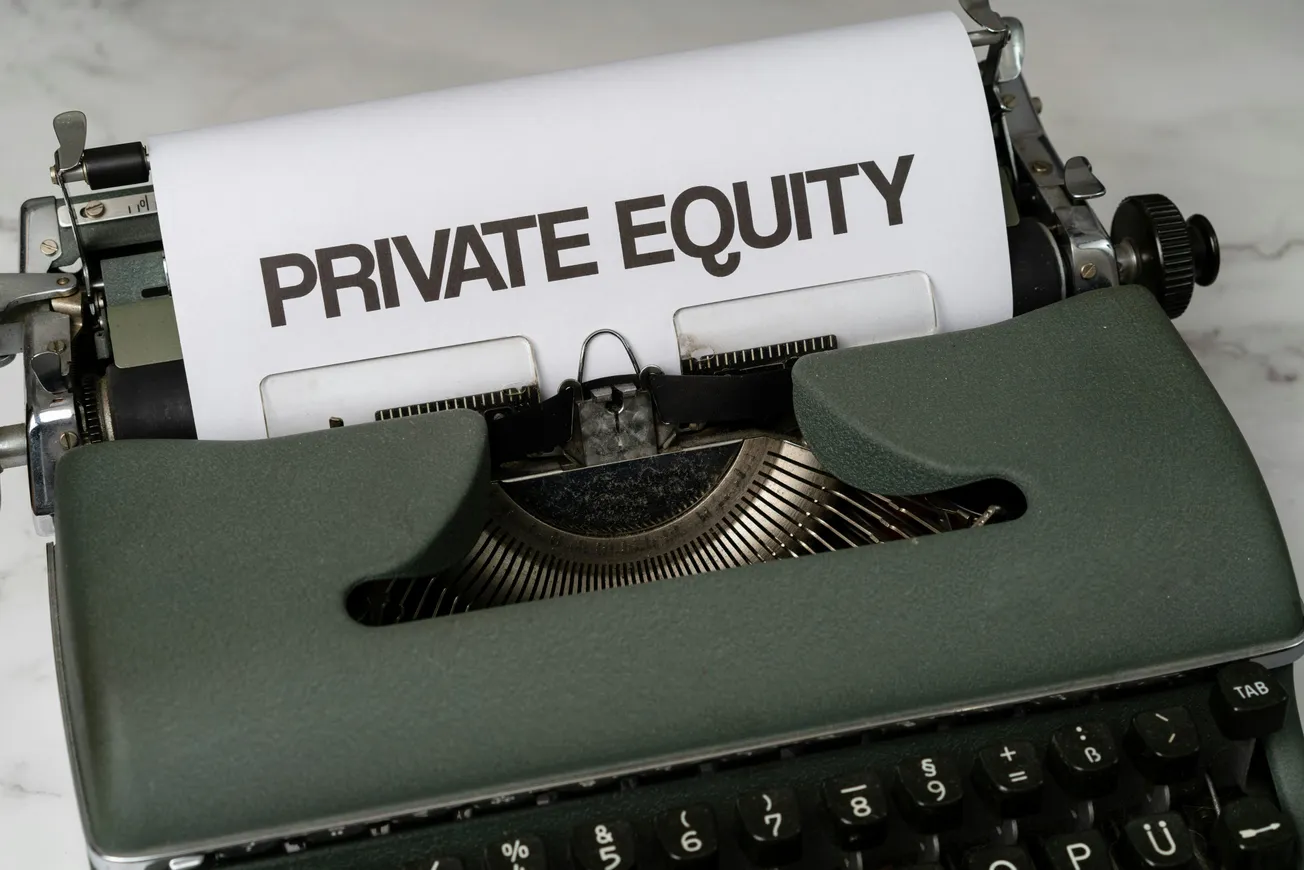 An old-fashioned green typewriter with a paper showing the words "PRIVATE EQUITY" in bold. The tone is nostalgic and professional.
