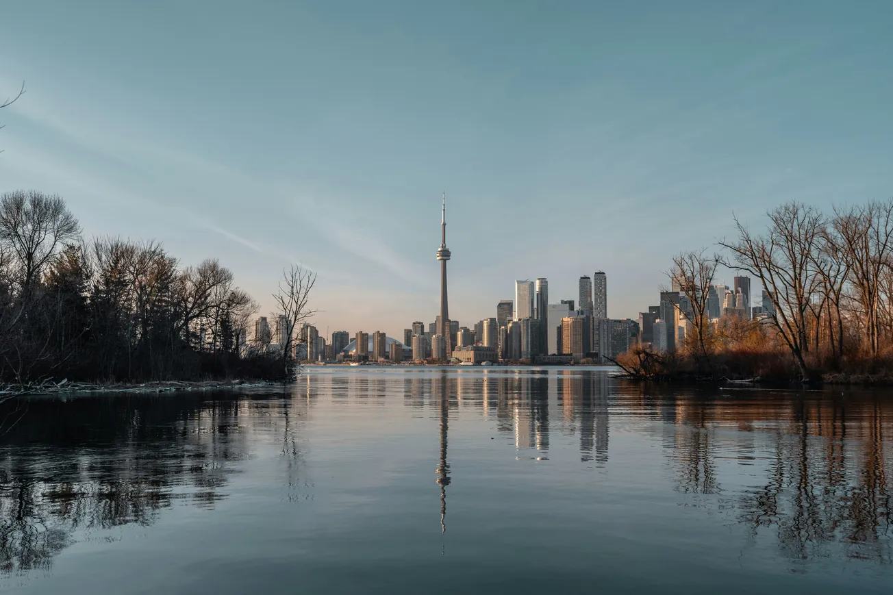 A scenic view of Toronto from the water, highlighting the city's skyline with its distinctive architecture and waterfront.